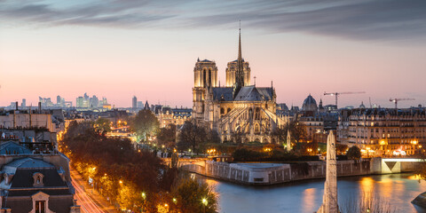 Panoramic of Paris city and Notre Dame cathedral at twilight, France