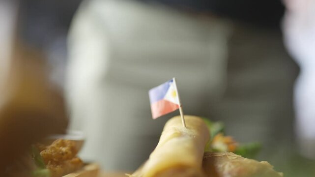 A flag is stuck on a piece of food. The flag is from the Philippines