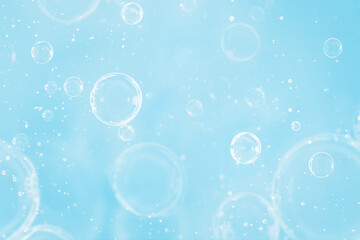 Air bubbles rise in the clear, blue water