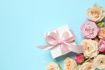 Beautiful composition with peony roses with gift box on color background