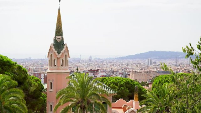 Barcelona. View of Park Guell from the terrace. Gaudi's colorful tower. Summer park. Tourist recreation area.