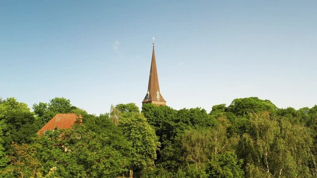 Drone ascending in distance to Tower of St. Joseph's Church in Stargard, Poland