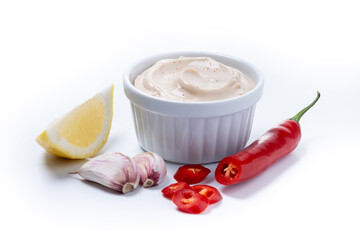 Chipotle sauce and spices in bowl isolated on white background
