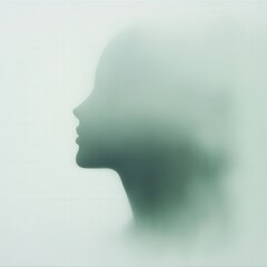 silhouette of a person's face in soft green light