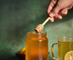 honey dripping from a glass jar