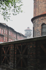 Fototapeta premium Decorative brick wall of the old town next to a neighborhood