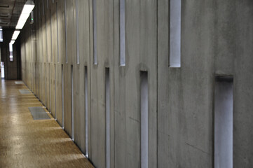 Concrete wall with long tall windows inside the modern building