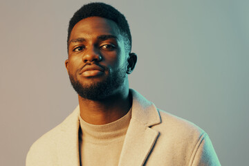 Obraz premium Confident young African man in stylish clothes posing against a soft green background, showcasing modern fashion and self assurance