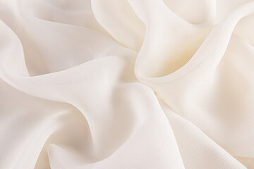 Obraz premium Stylish wedding background silk, chiffon fabric. Light airy waves of fabric in a creamy delicate tone. A copy of the space. layout for design.