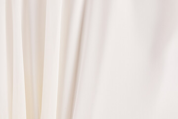 Obraz premium Beautiful wedding background of delicate silk, satin, chiffon fabric. Soft, elegant, parallel folds of fabric. space for text. The concept of wedding.