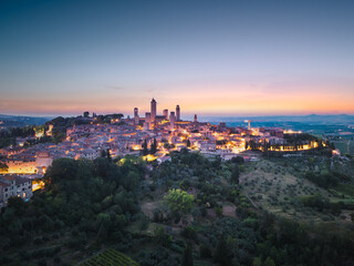 Aerial view of San Gimignano medieval town towers skyline and countryside landscape panorama on sunset. Tuscany, Italy, Europe.