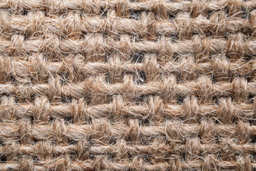 Natural jute fabric with intricate weave patterns showcasing texture and craftsmanship during daylight