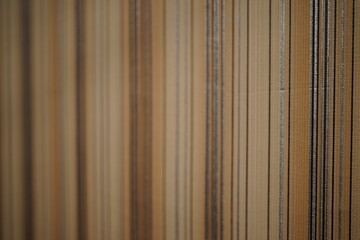 Fototapeta premium Textured wall featuring vertical lines of varying shades and materials