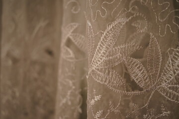 Intricate lace embroidery showcases skillful craftsmanship in textile design