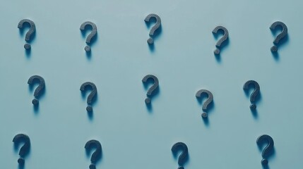 Multiple question marks arranged in a pattern on a blue background conveying curiosity and uncertainty