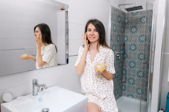 Woman applying hydrogel under-eye recovery patches enriched with collagen, vitamin E, provides intensive hydration and diminishes the signs of aging, helps reduse eye puffiness. Face skincare beauty.