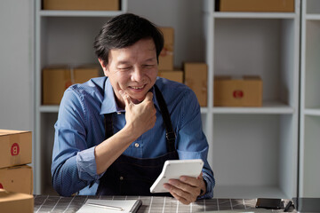 Smiling warehouse manager reviewing inventory on a tablet for efficient operations.