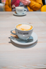 The cup of cappuccino on the table 