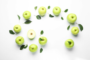 Flat lay composition with fresh apples and green leaves on white background