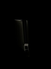 A moody and atmospheric night photograph. The deep shadows and contrast between darkness and light create a sense of mystery and intrigue.