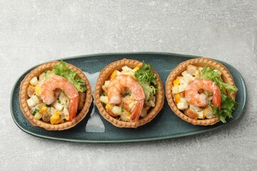 Tartlets with delicious filling on grey table, top view