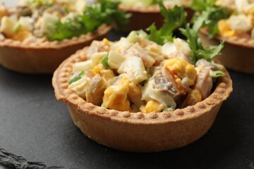 Tartlets with delicious filling on table, closeup