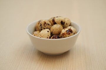 Speckled Quail Eggs in a Simple White Bowl