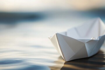 Obraz premium A simple paper boat floats on the surface of calm water, perfect for illustration or decoration