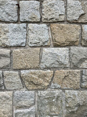 uneven stone wall texture background in brown and grey color