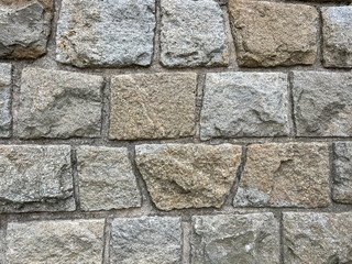 uneven stone wall texture background in brown and grey color