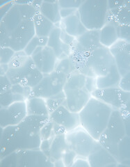 Closeup of desaturated transparent clear calm water surface texture with splashes and bubbles. Trendy abstract nature background, smooth light. with white shades