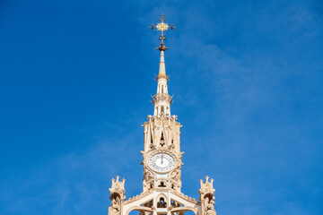 A close-up of the ornate clock tower at Sant Pau, showcasing sculpted details, Roman numerals, and...