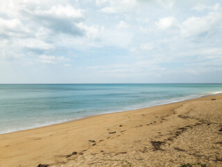Fototapeta premium Aerial view Beach waves crashing on sandy shore