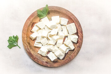 pieces of white tofu in a wooden plate