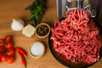 The concept of healthy eating, cooking. Close-up view from above of a dark plate with red minced...