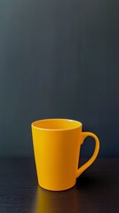 Vibrant Yellow Mug on Dark Table - Simple and Modern Design