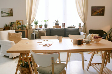 Medium close up of tea set and domino on top of table in living room of nursing home