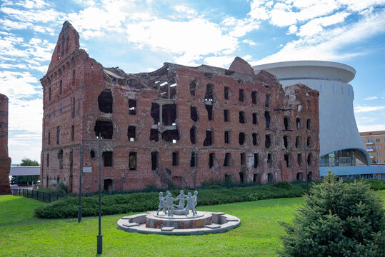 VOLGOGRAD, RUSSIA - SEPTEMBER 19, 2021: Sculpture "Children's Round dance" on the background of the destroyed Gergardt mill. Volgograd