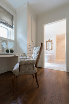 A dressing table and chair and bathroom in a house in Virginia, USA.
