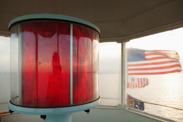 Close up of red lamp and American flags in a lighthouse