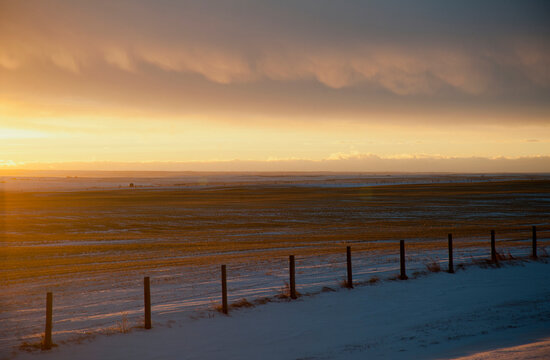 Dusk on the prairies in rural Saskatchewan, and sunlight on the horizon line.