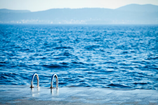 A ladder leading down to the water for swimmers in the Old City district of Zadar, Croatia.