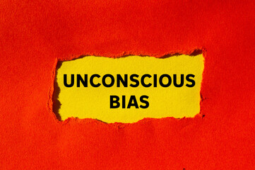 Unconscious bias message written on ripped torn red paper on yellow background. Conceptual...