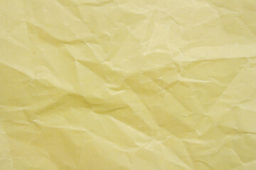 Crumpled yellow paper as background creased craft paper texture