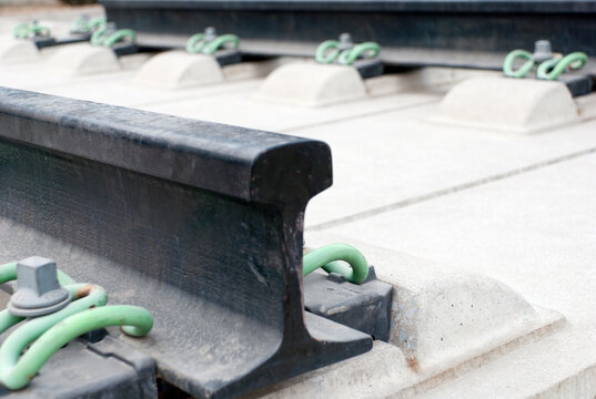 Close up of the metalwork of railway tracks, pinions and sleepers.