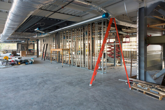 A commercial building under construction with roof ducts and light gauge steel framing.