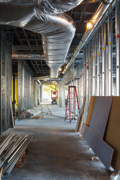 A commercial building under construction with roof ducts and light gauge steel framing.