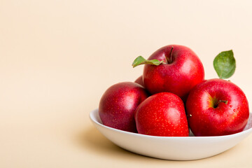 juicy red apples in a bowl or plate on the table top view. Copy space
