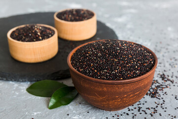 quinoa seeds in bowl on colored background. Healthy kinwa in small bowl. Healthy superfood