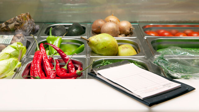 Receipts booklet on the counter of a fresh ingredients display.